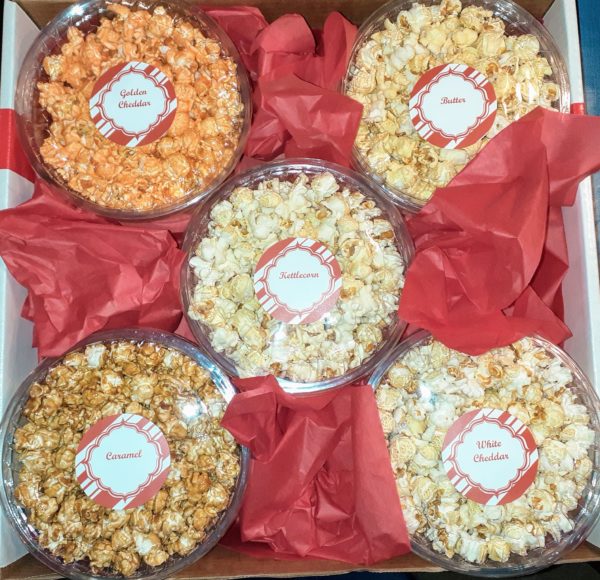 A view from above of 5 popular Best Darn Kettlecorn flavors: Golden Cheddar, Butter, Kettlecorn, Caramel, and White Cheddar.